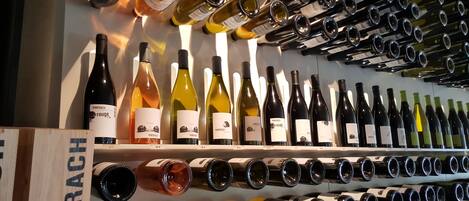 A wine rack with various bottles of wine, including red, white, and rosé.