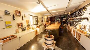 A wine shop with wooden shelves and a barrel in the center.