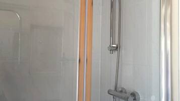 Shower, hair dryer, towels, toilet paper