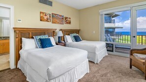 A hotel room with two beds, a balcony with a view of the ocean, and artwork on the wall. - Kapalua Bay Villa 34B2 By Parrish Maui - Oceanfront panoramic views (Kapalua)
