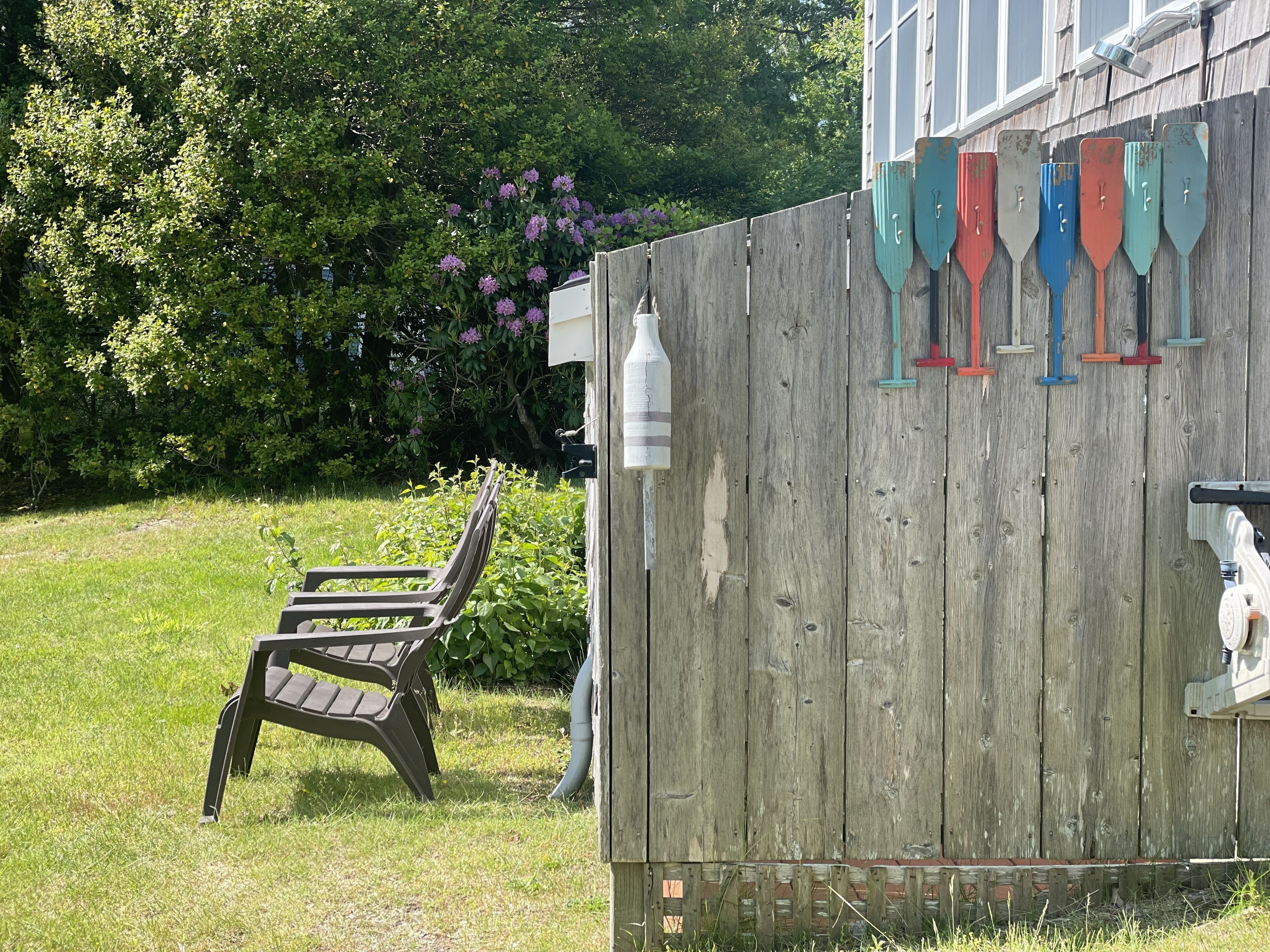 amazing outdoor shower with bathing suits or towels hanger on the side.