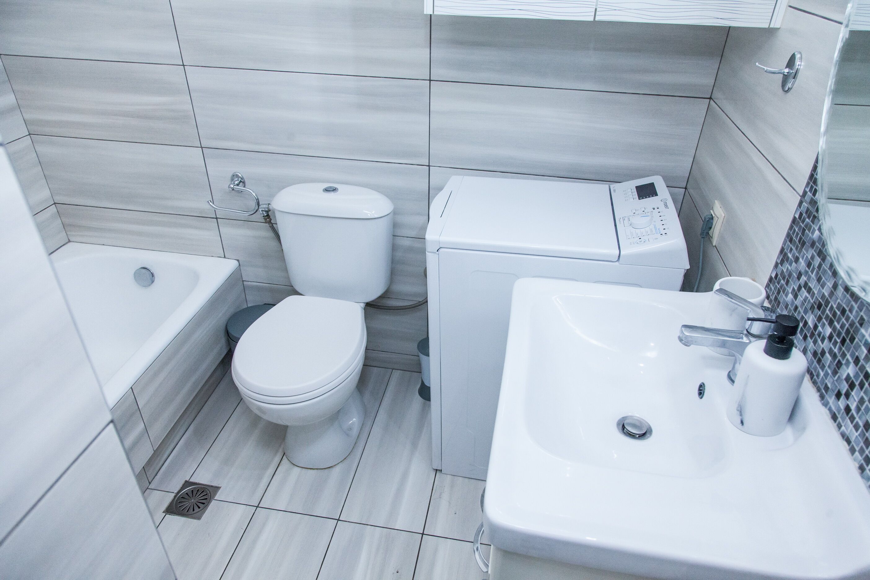 A modern bathroom with a toilet, bidet, and sink.
