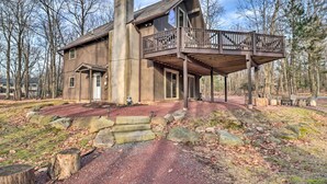 A rustic cabin with a wooden deck and a large chimney. - Lake Harmony Access: Home w/ Game Room + Fire Pit! (Lake Harmony)