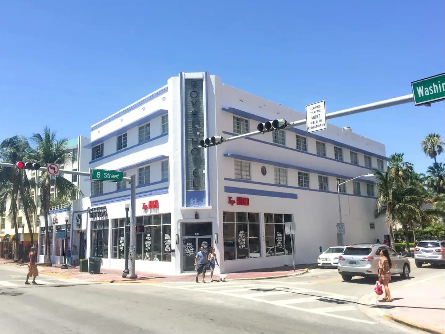 A hotel with a modern design, located at the intersection of 8th Street and Washington.