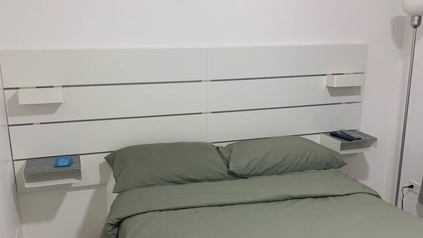 A small, neatly arranged bedroom with a single bed, a bedside table, and a nightstand. - Hotel Conquistador Santo Domingo  (Santo Domingo)