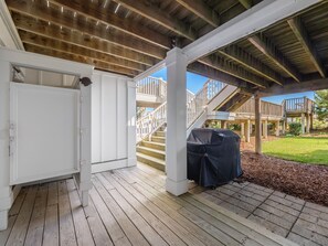 Enjoy al fresco dining and take in the views from the covered deck, which offers a barbecue grill and access to an upper level with a staircase.