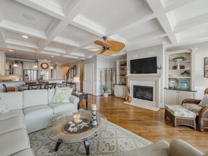 Relax in style with a comfortable L-shaped sofa and fireplace, perfect for social gatherings.
