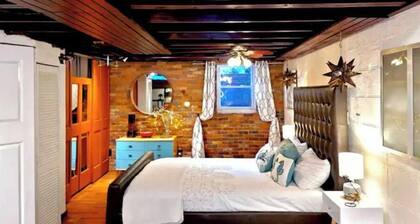 Live in this iconic East Side lower level apartment