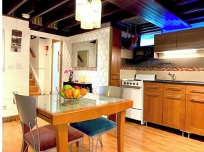Enjoy cooking in this well-equipped kitchen with a central island, stove, and microwave.
