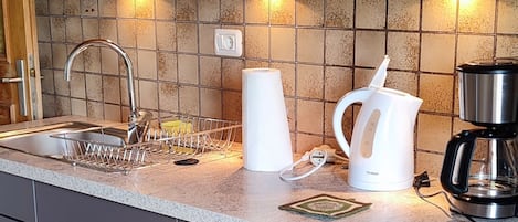 Fridge, coffee/tea maker, electric kettle, cookware/dishes/utensils
