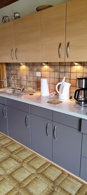 Fridge, coffee/tea maker, electric kettle, cookware/dishes/utensils