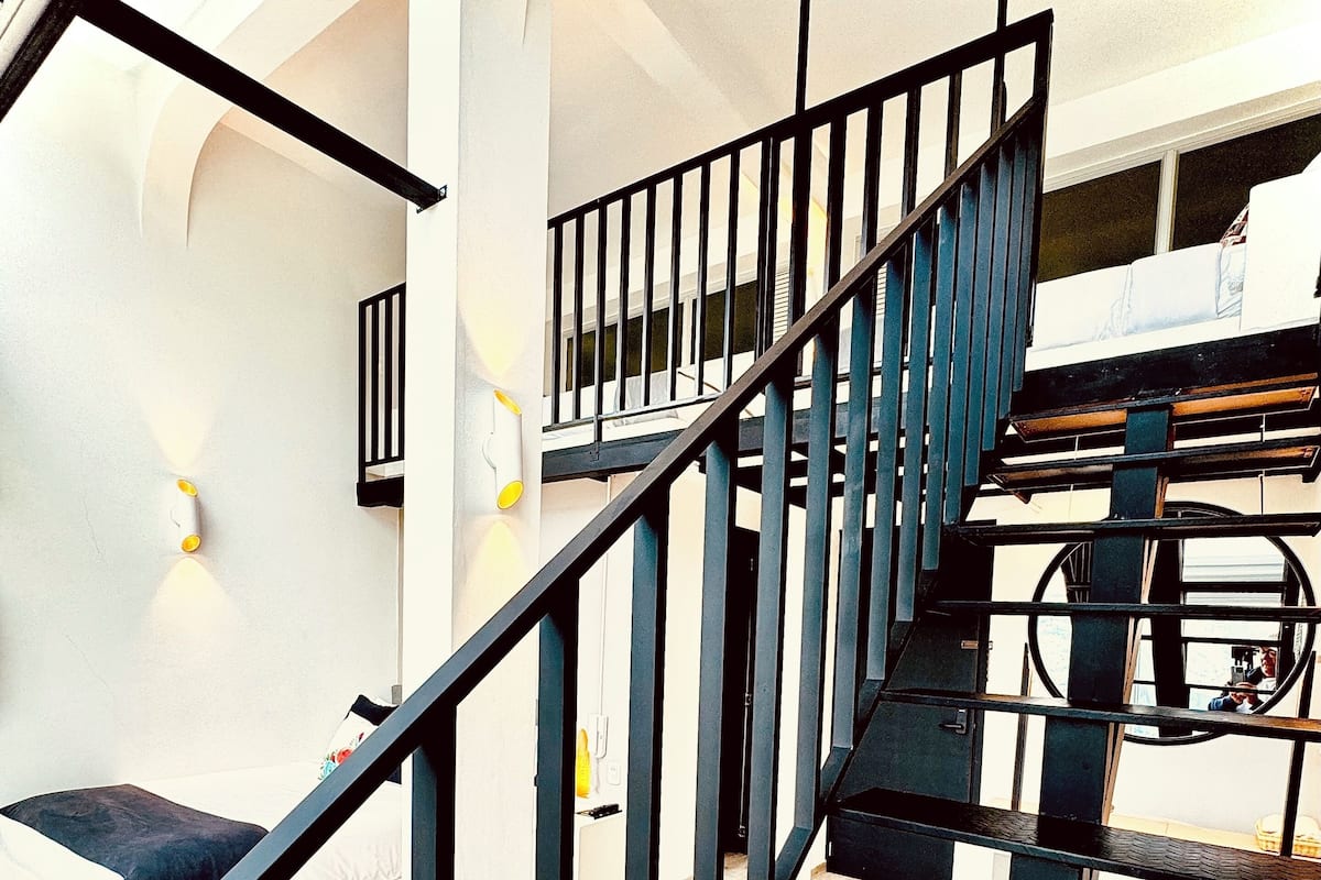 A modern staircase with black railings and a white interior.
