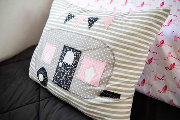 A pillow with a patchwork design, featuring a vehicle and polka dots. - CUTE 1962 RV with huge screened in gazebo ~1 mile from winery (Tow)