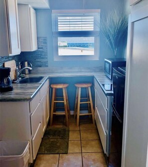 Fridge, microwave, stovetop, coffee/tea maker