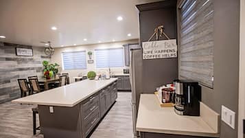 Fridge, microwave, paper towels, dining tables