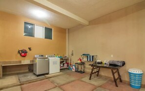 Enjoy a compact space with a kitchenette, washing machine, and refrigerator for basic needs.