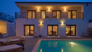 A modern two-story building with a swimming pool, balconies with railings, and outdoor seating areas. - Villa Kucha 26b with Pool & Seaview (Vrbnik (Krk))
