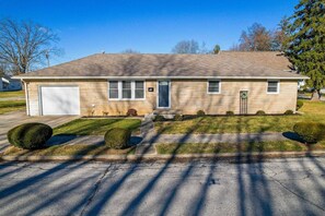 Stroll up to the charming entrance, flanked by well-manicured topiary bushes, and enter your home through the front door.