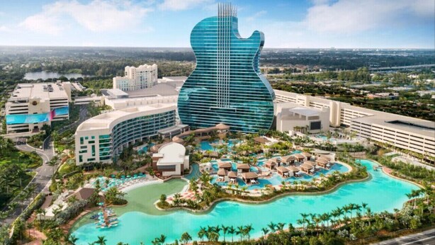Un complexe hôtelier doté d’un grand bâtiment en forme de guitare, de plusieurs piscines et d’un aménagement paysager luxuriant.