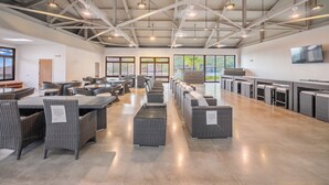 A spacious indoor area with high ceilings, multiple seating arrangements, and large windows providing natural light. - 🌺 Oahu Ocean & Mountain Views • Sleeps 14 • Pool, Spa, Near Beach, AC & BBQ 🌺 (Waianae)