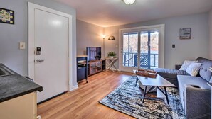 Una sala de estar moderna con un sofá, una mesa de centro y vistas a un balcón.
