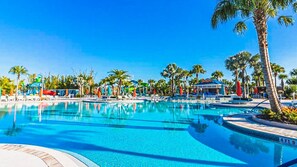 A large outdoor swimming pool with multiple lanes, surrounded by palm trees and lounge chairs. - 8BR @ Windsor Island/Star Wars Gameroom/Themed BR (Davenport)