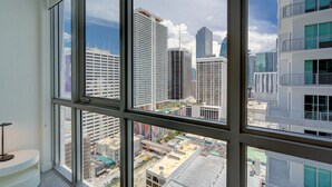 A high-rise building with multiple floors and a view of the cityscape through large windows.