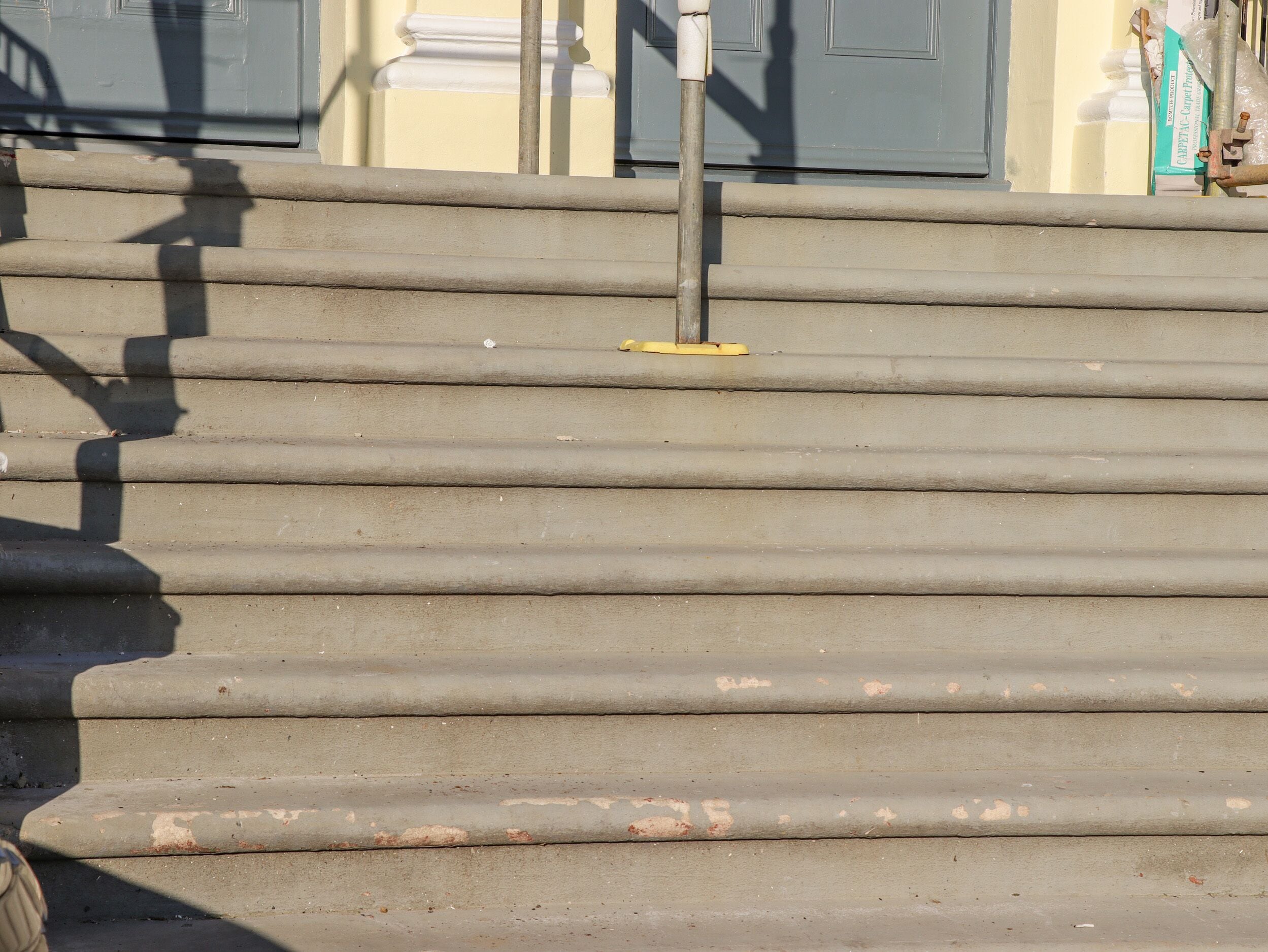A set of concrete steps leading up to a building entrance.