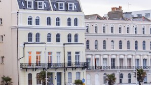 A row of classic European-style buildings with uniform facades, multiple windows, and balconies. - The Old Spy Headquarters (Folkestone)
