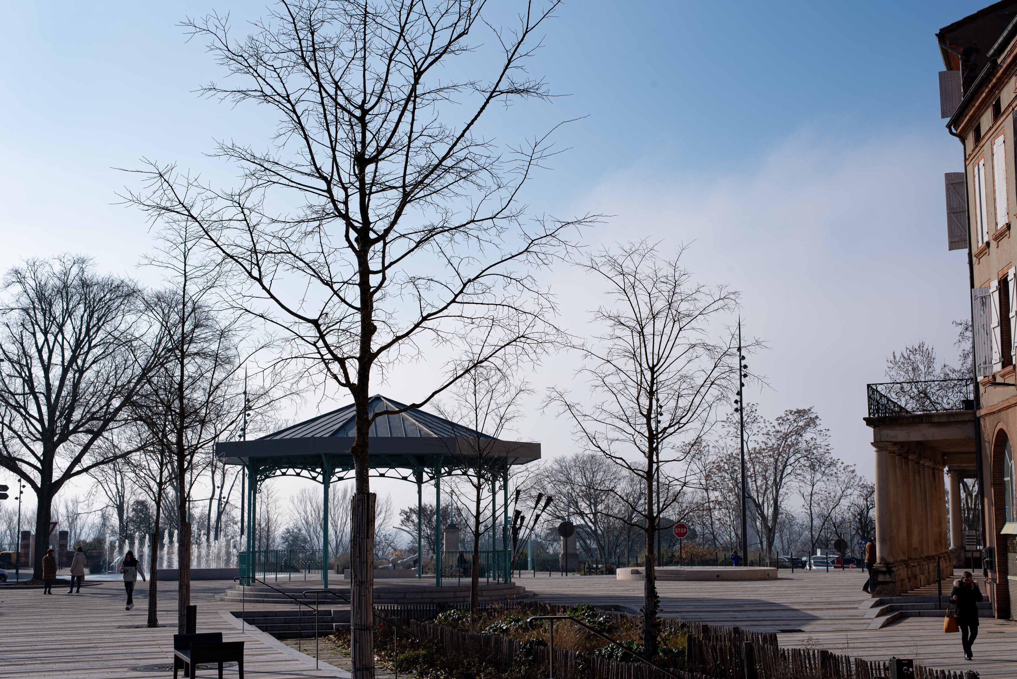 A park with a gazebo, benches, and a fountain.