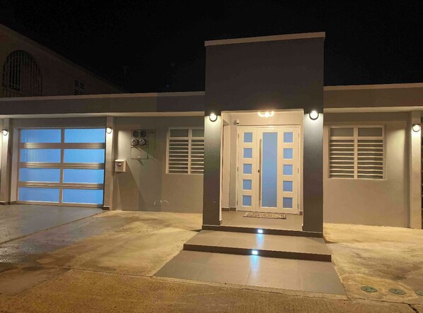 Enter through the double doors, flanked by wall sconces, into a clean, contemporary space.