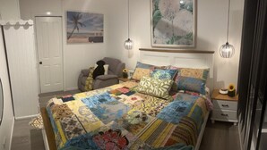 A bedroom with a large bed, a nightstand, a chair, and a door. - Newly Listed and Centrally located , walk to restaurant's , cafes and shopping , (Boondall)