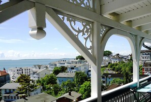 A coastal town with white buildings, a pier, and a view of the sea.