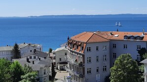 A coastal cityscape with buildings and a view of the sea.