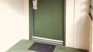 A green door with a sign reading "Whaler's Hut" and the number "129". - One King bedroom Cottage (Carmel-by-the-Sea)