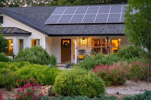 Surrounded by a serene garden, this property offers a peaceful retreat with a modern design and sustainable features.