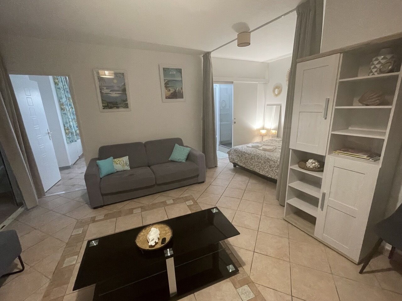 A living room with a sofa, a coffee table, and a wardrobe.