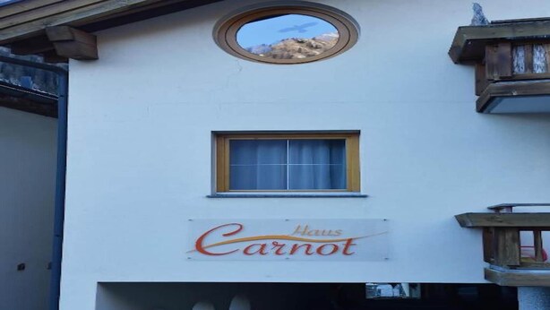 A building with a sign reading "Haus Carnot" and a small window above it. - Retreat in Samnaun Alps (Samnaun)