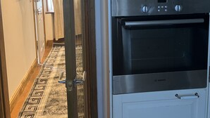Una cocina con horno Bosch y microondas Kenwood.