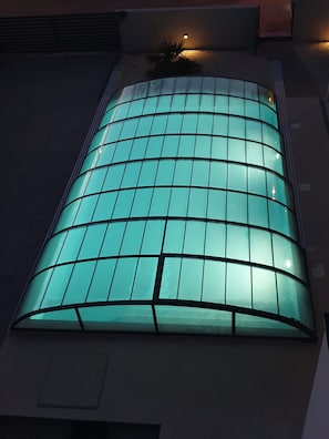 A modern building with a curved glass facade.