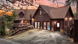 A log cabin with a porch, a staircase, and a pool. - Grand Mtn Splash ~ Indoor Pool, Arcade, Theater & More! (Sevierville)