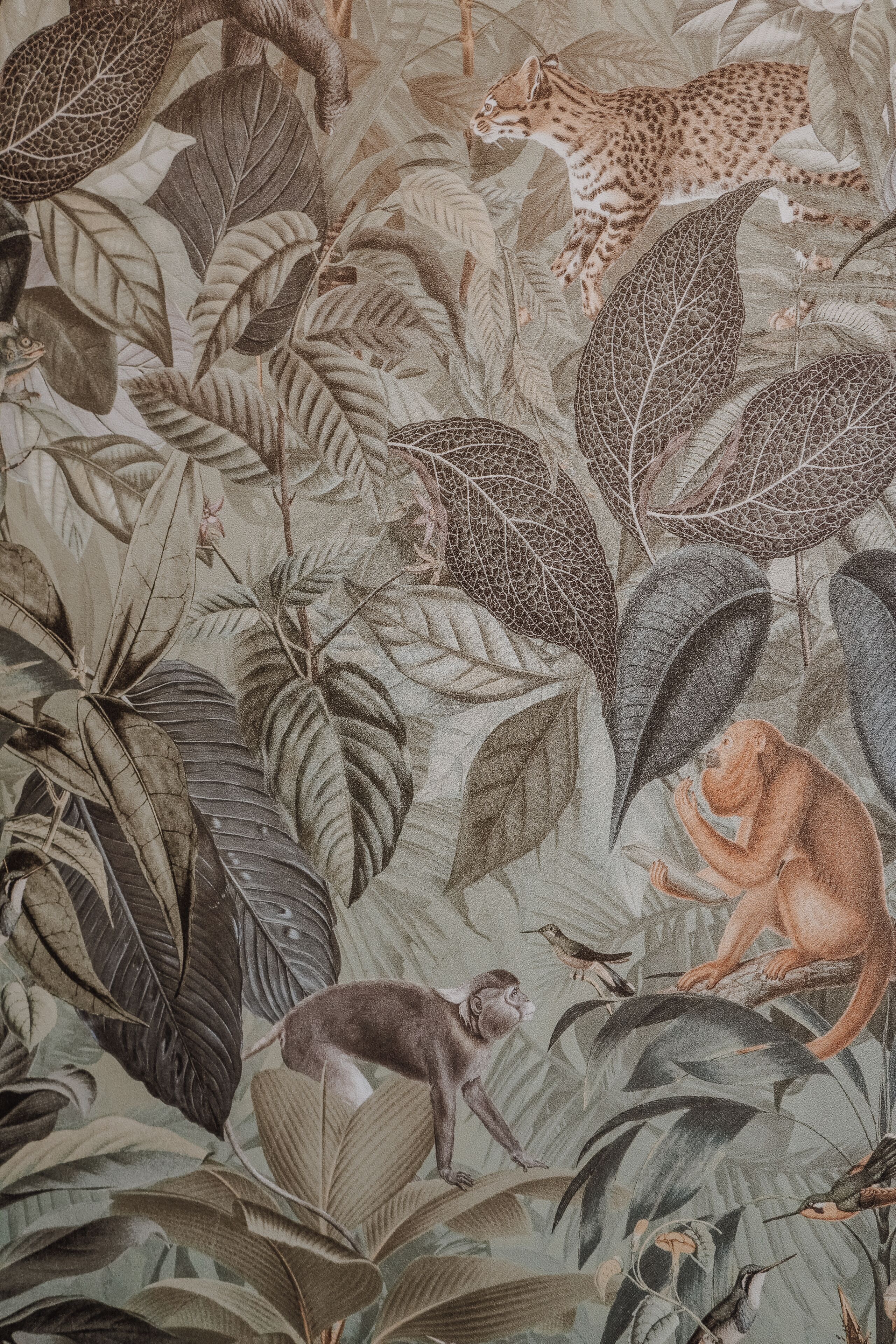 Un mural detallado con diversas figuras de animales y follaje.