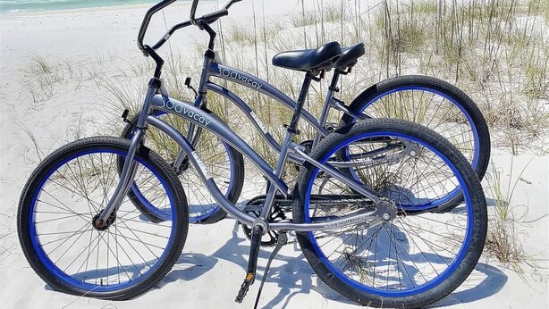 A bicycle on a sandy beach with a clear view of the ocean. - Magnolia By The Sea, Heated Community Pool, 3 Bikes, 4 Minute Walk to Private Beach - BeachWalk (Panama City Beach)