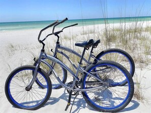 A bicycle on a sandy beach with a clear view of the ocean. - Seacrest West - BeachWalk (Panama City Beach)