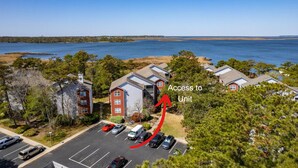 A residential area with houses and a parking lot. - Sunset Retreat 2 Bedroom Pet-Friendly Condo at Oyster Point (Kill Devil Hills)