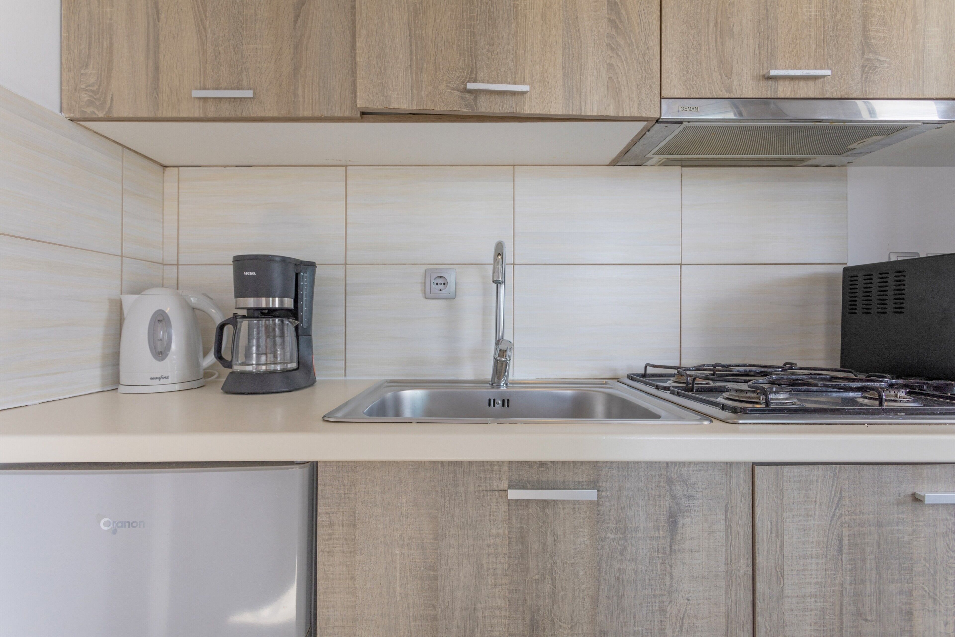 Fridge, microwave, stovetop, coffee/tea maker