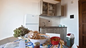 A kitchen with a refrigerator, wooden cabinets, a sink, and a trash bin. - Holiday Home 'Paese Albergo - Arconides' with Sea View, Balcony and Wi-Fi (Motta D'affermo)