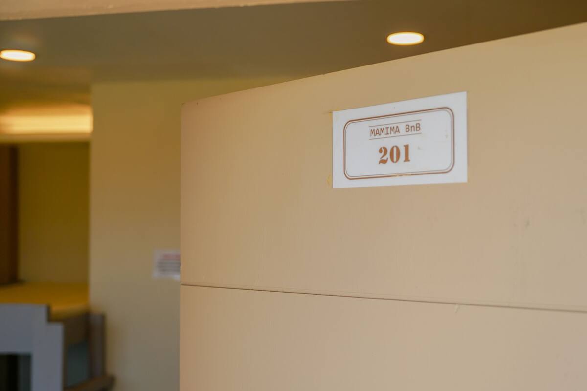 A wall with a sign indicating room number 201.