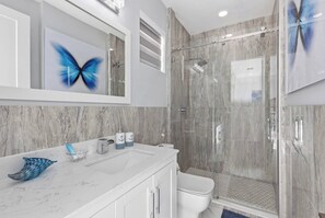Bathtub, hair dryer, towels, toilet paper
