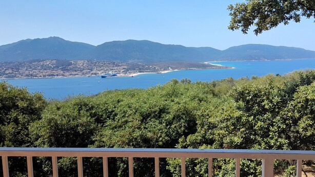 A coastal view with mountains, a beach, and dense greenery. - Close to the beaches, spacious, air conditioning, panoramic view of the gulf!  (OLMETO)